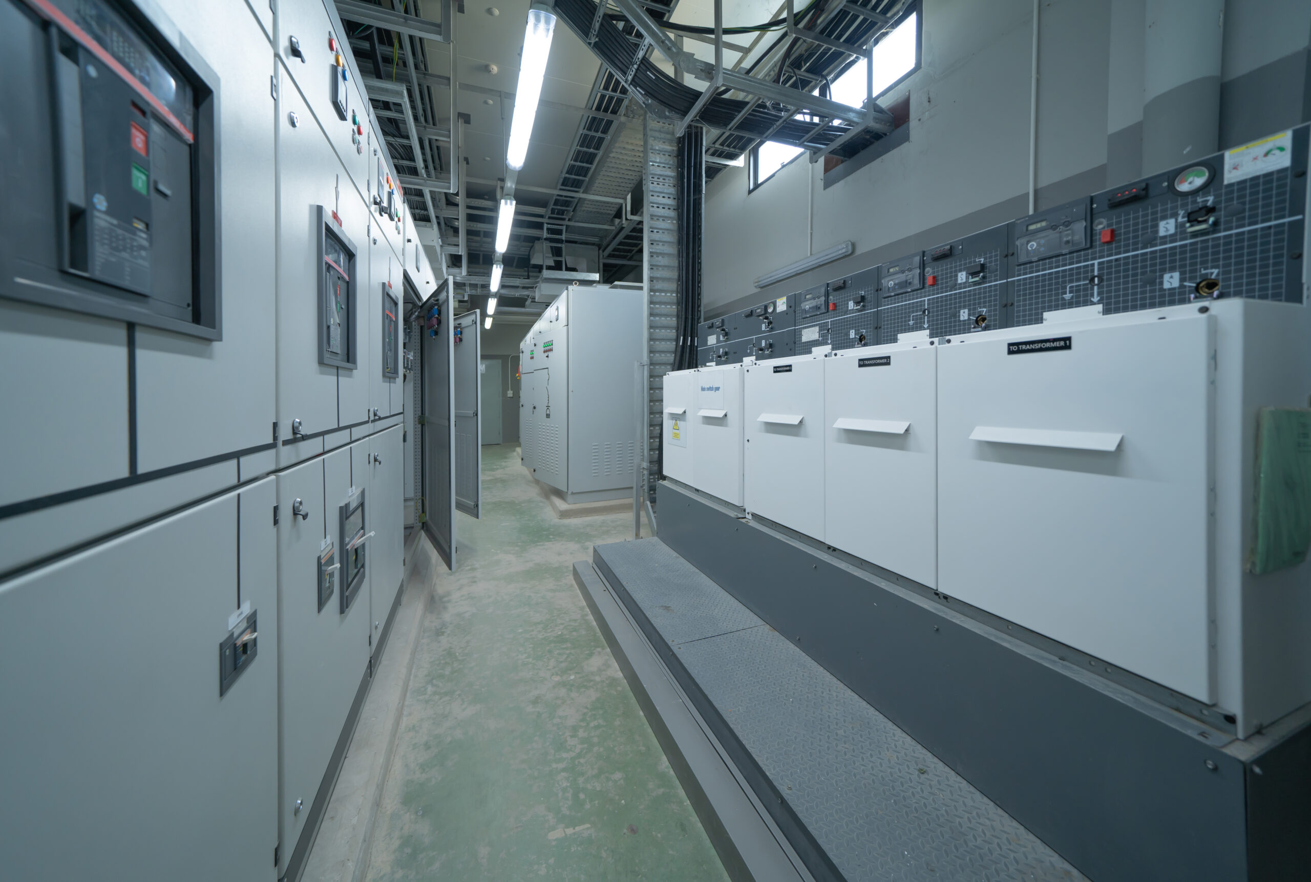 Interior of electrical room. Power energy motor machinery cabinets in control or server room, main operator station network and circuit center in industry factory manufacturing system. generator